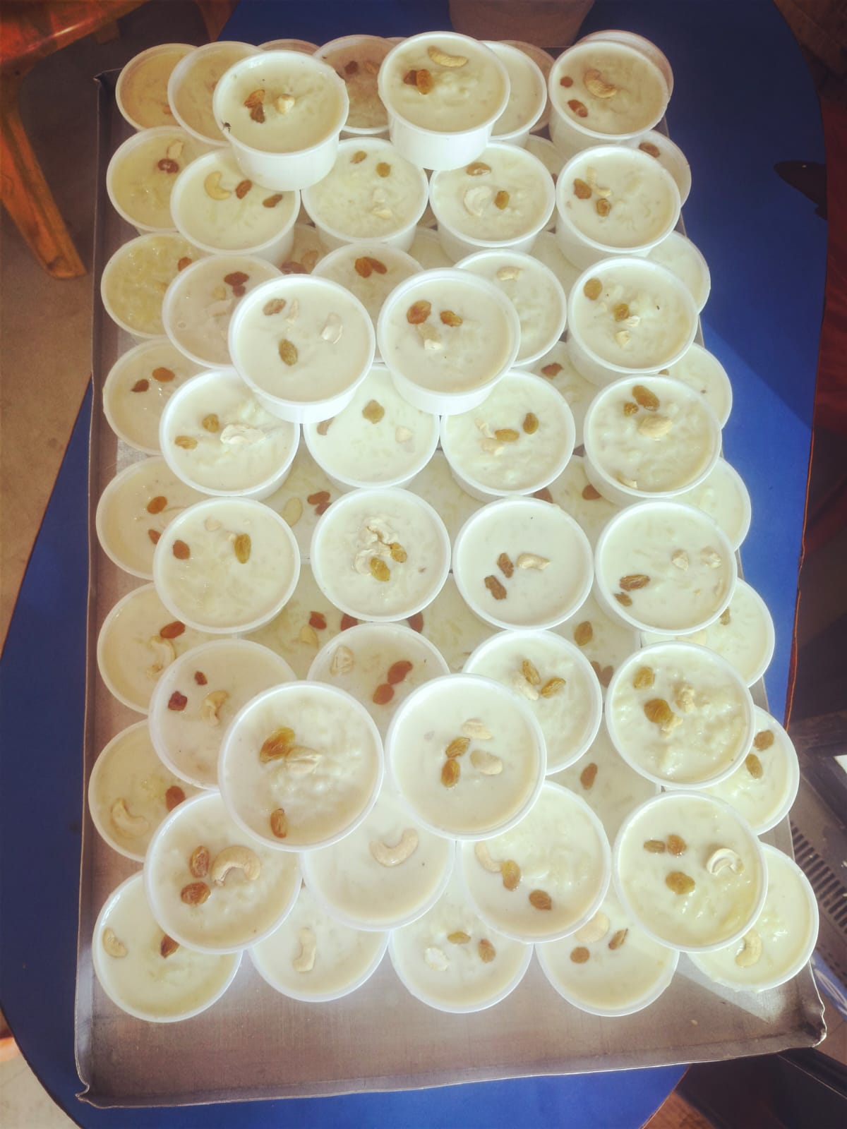 Cups of fresh dahi topped with raisins and cashew